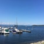 A marina filled with boats on a calm sea.